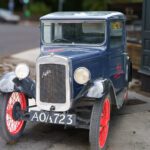 I WONDER IF MY CAR HAS ANY TRADE IN VALUE [OLD BABY AUSTIN CAR PARKED AT THE DROPPING WELL PUB]-239258-1