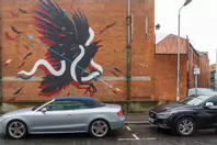 EXAMPLES OF STREET ART BY DANK AND SABEK [ON THE RED BRICK WALL ON TALBOT STREET IN BELFAST]-235444-1 MURAL ON TALBOT STREET