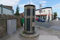 A FREESTANDING FINIAL-TOPPED CAST-IRON TRANSFORMER [DATING FROM 1900 AND LOCATED AT CONQUER HILL ROAD NEAR CLONTARF BUS GARAGE]-244413-1