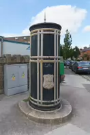 A FREESTANDING FINIAL-TOPPED CAST-IRON TRANSFORMER [DATING FROM 1900 AND LOCATED AT CONQUER HILL ROAD NEAR CLONTARF BUS GARAGE]-244414-1