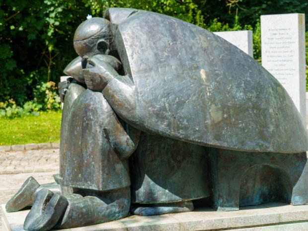 BY IMOGEN STUART ronze statue of pope John Paul II embracing two kneeling children, based on a photograph taken during the Pope's visit...