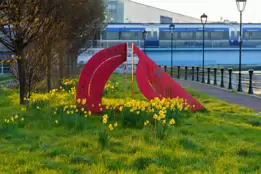 A RED METAL YOKE BY BOB SLOAN [THIS SCULPTURE IN BELFAST HAS NO NAME]-203537-1