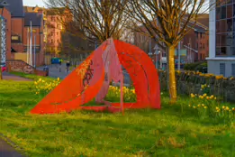 A RED METAL YOKE BY BOB SLOAN [THIS SCULPTURE IN BELFAST HAS NO NAME]-203533-1