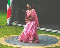 PERFORMING IN THE RAIN IN A BEAUTIFUL PINK DRESS [RAINDROPS ARE VISIBLE IN SOME PHOTOGRAPHS]-235640-1