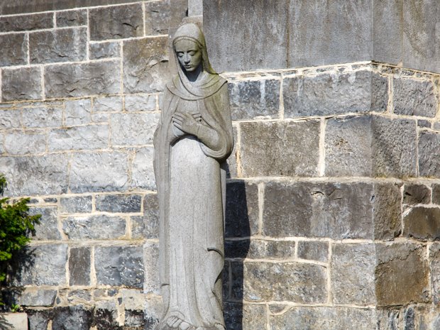 STATUE OUTSIDE THE CATHEDRAL The image of Mary crushing the serpent's head is a powerful symbol of her role in the redemption of humanity. It draws...