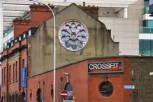 A ROUND WINDOW REPRESENTING THE WHEEL OF AN OLD SHIP [THE BUILDING WAS DEMOLISHED A FEW YEARS LATER]-234391-1