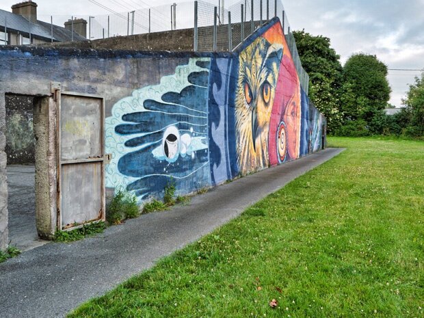 MICHAEL STREET MURAL JUNE 2025 The compelling mural on the Michael Street handball alley is primarily the creation of Kathrina Rupit, known as KinMx....