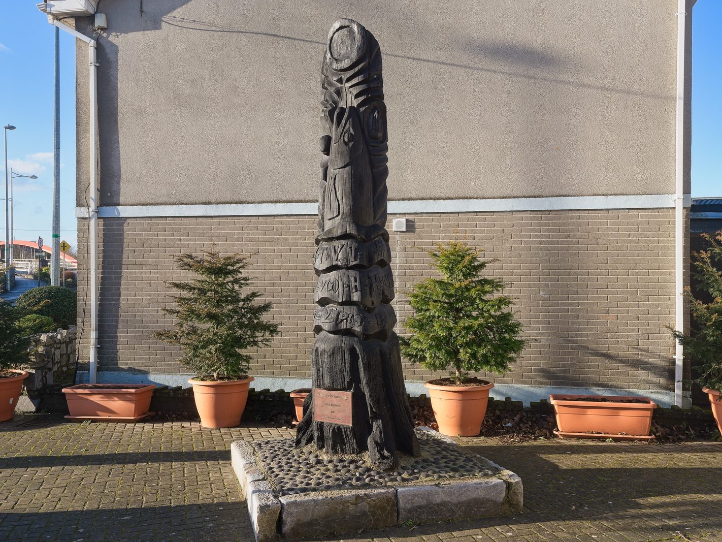A HUNGER FOR KNOWLEDGE BY JOEY BURNS PLUS A MURAL[A BOG OAK SCULPTURE REPRESENTING THE SALMON OF KNOWLEDGE]-225058-1