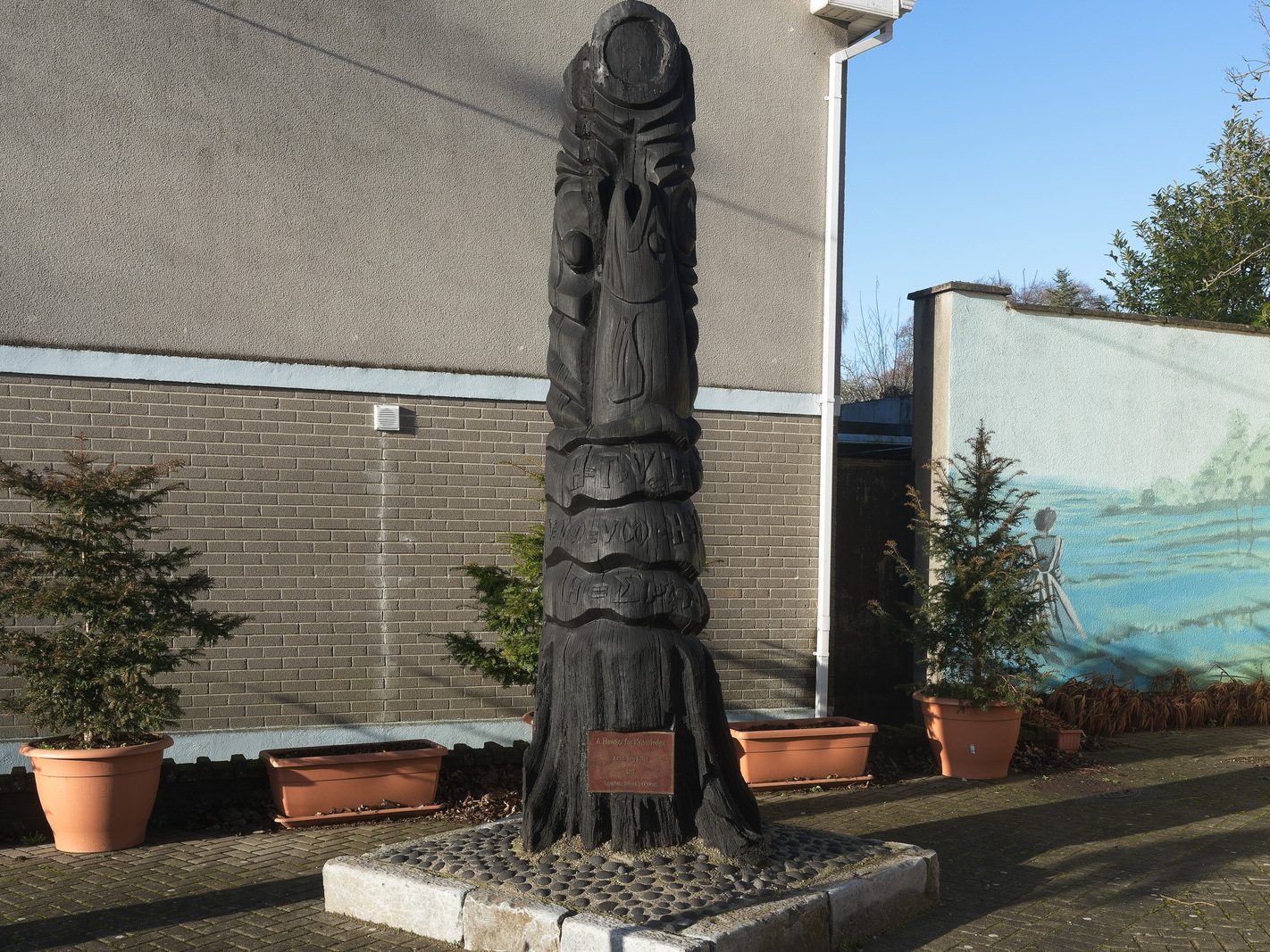 A HUNGER FOR KNOWLEDGE BY JOEY BURNS PLUS A MURAL[A BOG OAK SCULPTURE REPRESENTING THE SALMON OF KNOWLEDGE]-225059-1