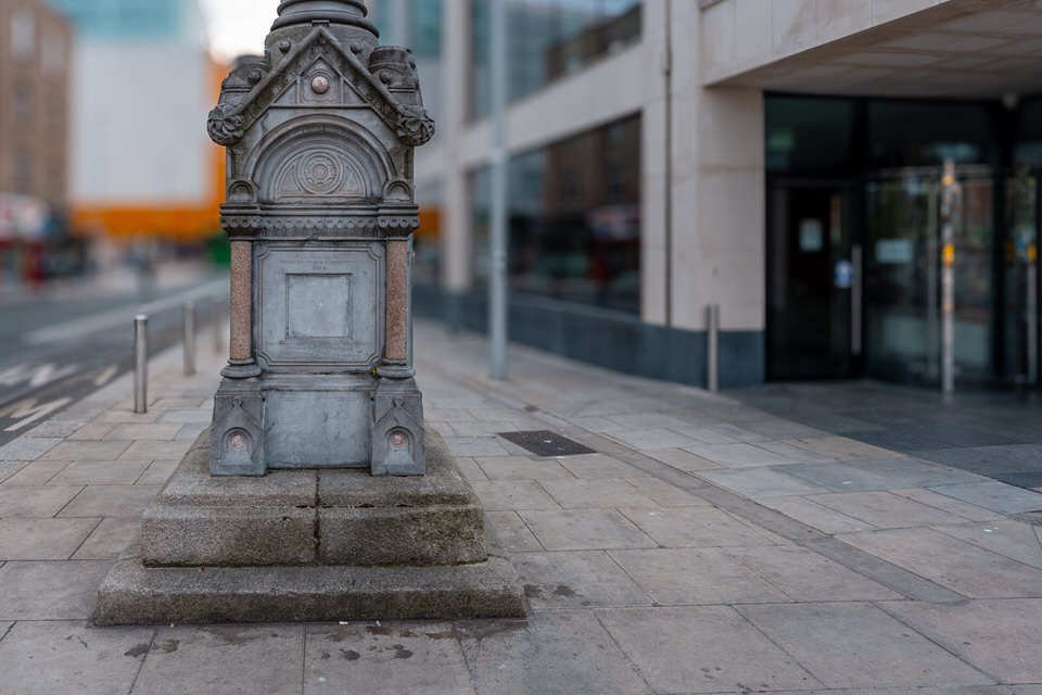 The memorial was moved because of the Luas tram extension. Specifically, it was relocated slightly in 2012 to accommodate the new Luas tram tracks on the street.
