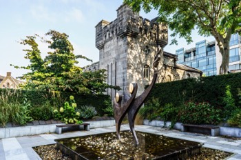  TWO STYLISED FIGURES WITH THE OLYMPIC FLAME - SPECIAL OLYMPICS MEMORIAL BY JOHN BEHAN 