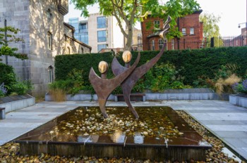  TWO STYLISED FIGURES WITH THE OLYMPIC FLAME - SPECIAL OLYMPICS MEMORIAL BY JOHN BEHAN 004 